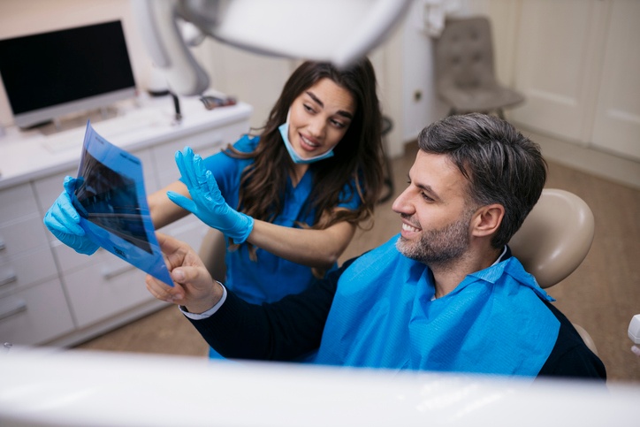 Dentist reviewing X-ray with patient at Smiles of Anderson for orthodontic care in Anderson, IN.